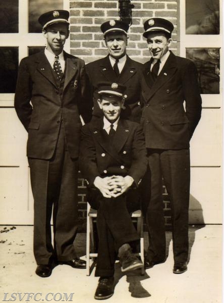 Back row:  Carroll Thiergartner, Ernest G. Ruths, Calia Cox
Sitting:  Chief Wm. Harrington